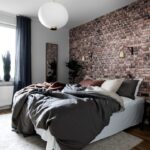 brick accent wall in bedroom